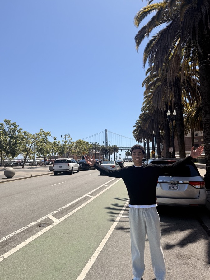 Benian in San Francisco with the Bay Bridge behind him